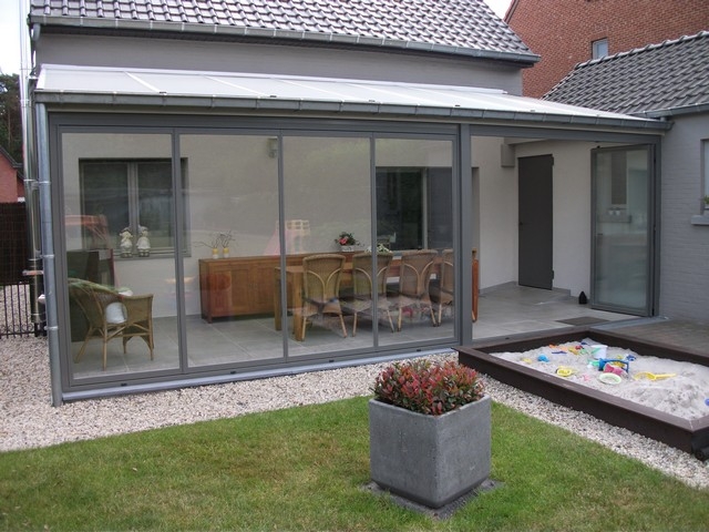 Black aluminum bifold glass doors fully opened connecting indoor living space to outdoor patio area