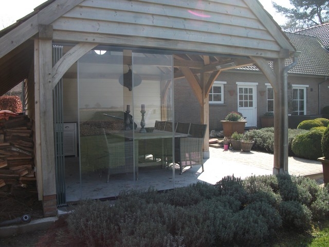 Black aluminum bifold glass doors fully opened connecting indoor living space to outdoor patio area