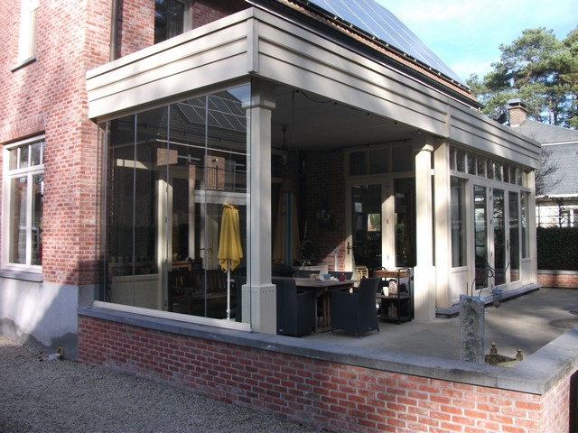 Black aluminum bifold glass doors fully opened connecting indoor living space to outdoor patio area