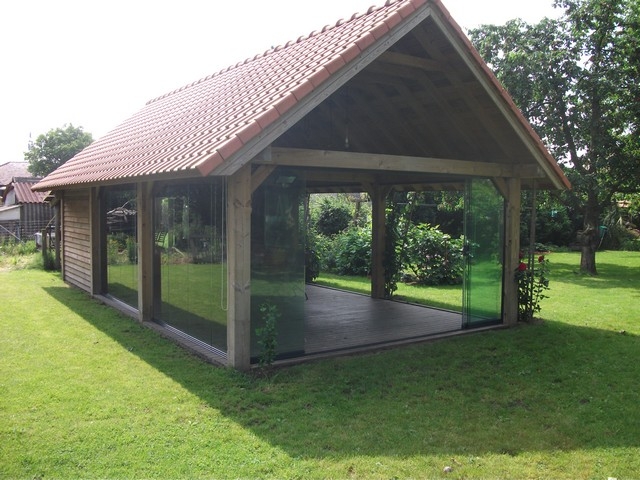 Black aluminum bifold glass doors fully opened connecting indoor living space to outdoor patio area