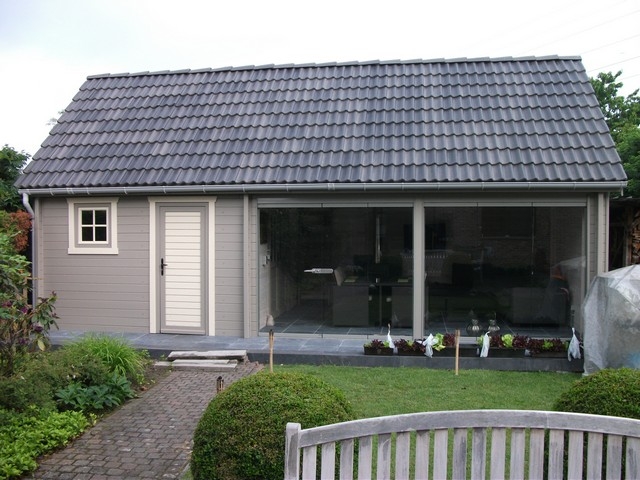 Black aluminum bifold glass doors fully opened connecting indoor living space to outdoor patio area