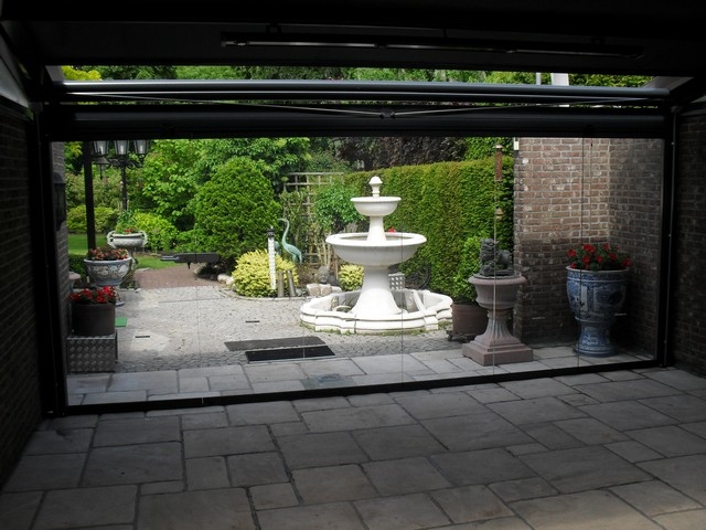 Black aluminum bifold glass doors fully opened connecting indoor living space to outdoor patio area