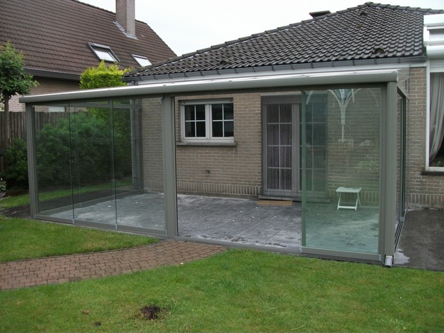 Black aluminum bifold glass doors fully opened connecting indoor living space to outdoor patio area